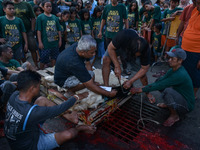 (EDITOR'S NOTE: Graphic content) Residents are watching the slaughtering of a goat during the Eid al-Adha celebration in the courtyard of th...