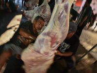 (EDITOR'S NOTE: Graphic content) Residents are working together to cut hundreds of goats to be distributed to the public during the Eid al-A...