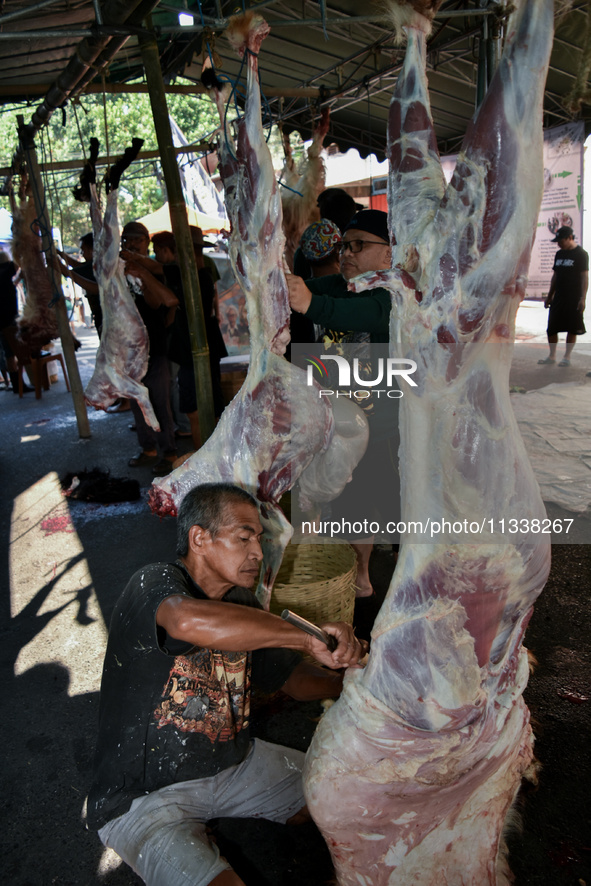 (EDITOR'S NOTE: Graphic content) Residents are working together to cut hundreds of goats to be distributed to the public during the Eid al-A...