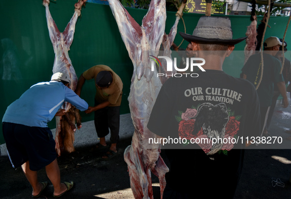 (EDITOR'S NOTE: Graphic content) Residents are working together to cut hundreds of goats to be distributed to the public during the Eid al-A...