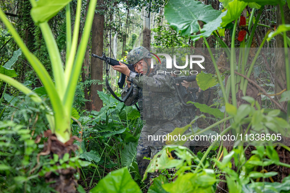 Officers and soldiers are conducting a comprehensive anti-terrorism drill in the wild in an unfamiliar area in Beihai, China, on June 17, 20...