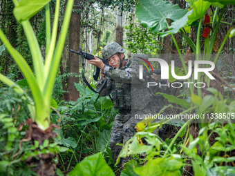 Officers and soldiers are conducting a comprehensive anti-terrorism drill in the wild in an unfamiliar area in Beihai, China, on June 17, 20...