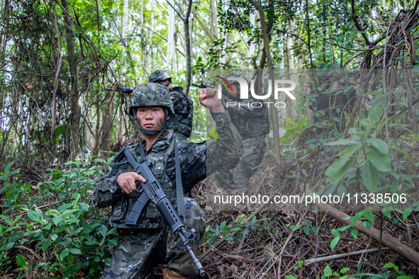 Officers and soldiers are conducting a comprehensive anti-terrorism drill in the wild in an unfamiliar area in Beihai, China, on June 17, 20...