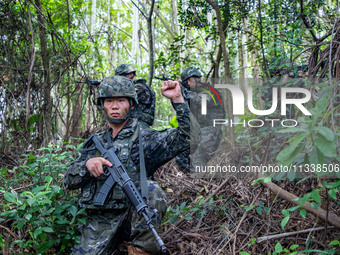 Officers and soldiers are conducting a comprehensive anti-terrorism drill in the wild in an unfamiliar area in Beihai, China, on June 17, 20...