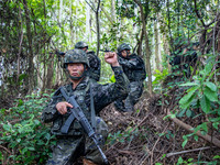 Officers and soldiers are conducting a comprehensive anti-terrorism drill in the wild in an unfamiliar area in Beihai, China, on June 17, 20...