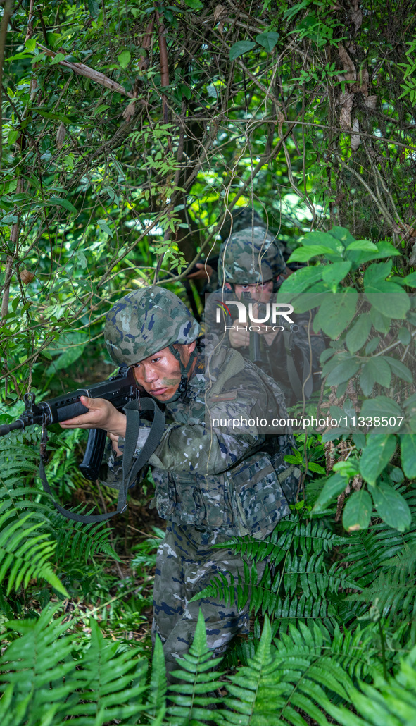 Officers and soldiers are conducting a comprehensive anti-terrorism drill in the wild in an unfamiliar area in Beihai, China, on June 17, 20...