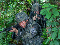 Officers and soldiers are conducting a comprehensive anti-terrorism drill in the wild in an unfamiliar area in Beihai, China, on June 17, 20...