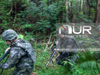 Officers and soldiers are conducting a comprehensive anti-terrorism drill in the wild in an unfamiliar area in Beihai, China, on June 17, 20...