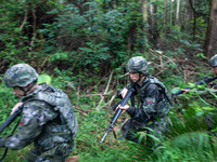 Officers and soldiers are conducting a comprehensive anti-terrorism drill in the wild in an unfamiliar area in Beihai, China, on June 17, 20...