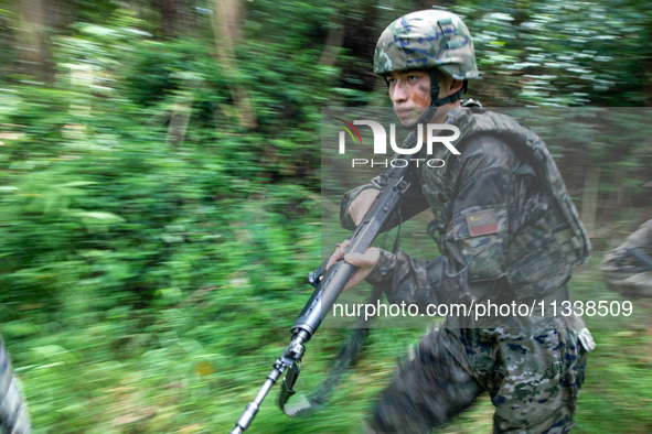 Officers and soldiers are conducting a comprehensive anti-terrorism drill in the wild in an unfamiliar area in Beihai, China, on June 17, 20...