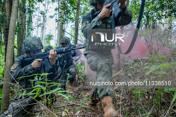 Officers and soldiers are conducting a comprehensive anti-terrorism drill in the wild in an unfamiliar area in Beihai, China, on June 17, 20...