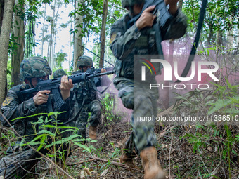 Officers and soldiers are conducting a comprehensive anti-terrorism drill in the wild in an unfamiliar area in Beihai, China, on June 17, 20...