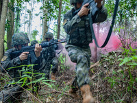 Officers and soldiers are conducting a comprehensive anti-terrorism drill in the wild in an unfamiliar area in Beihai, China, on June 17, 20...