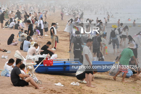 Tourists are enjoying the cool water at the No. 1 Bathing Beach in Qingdao, China, on June 17, 2024. 