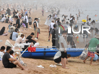 Tourists are enjoying the cool water at the No. 1 Bathing Beach in Qingdao, China, on June 17, 2024. (