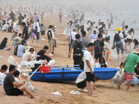 Tourists are enjoying the cool water at the No. 1 Bathing Beach in Qingdao, China, on June 17, 2024. (