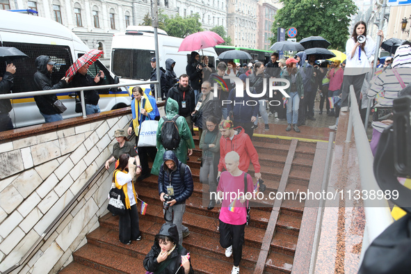 Activists are going down to an underground passage at a metro station during the Equality March organized by KyivPride NGO for the first tim...