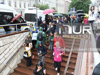 Activists are going down to an underground passage at a metro station during the Equality March organized by KyivPride NGO for the first tim...