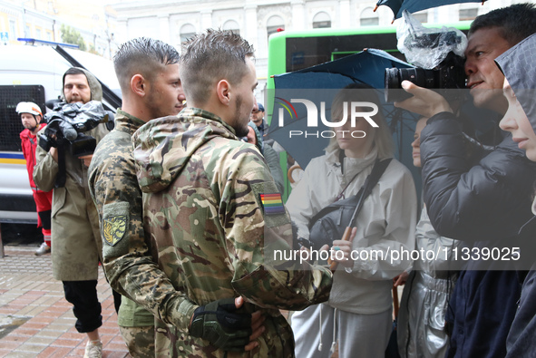 Two Ukrainian servicemen are speaking to the press during the Equality March organized by KyivPride NGO for the first time since the 2022 Ru...