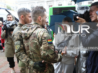 Two Ukrainian servicemen are speaking to the press during the Equality March organized by KyivPride NGO for the first time since the 2022 Ru...