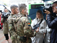 Two Ukrainian servicemen are speaking to the press during the Equality March organized by KyivPride NGO for the first time since the 2022 Ru...