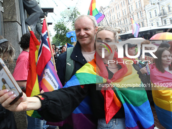 Demonstrators are taking a selfie during the Equality March organized by KyivPride NGO for the first time since the 2022 Russian invasion of...