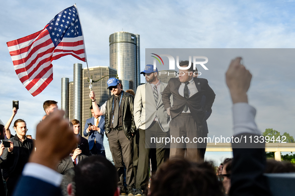 Members of America First, a far-right white Christian nationalist group, are holding a prayer while awaiting their leader Nick Fuentes to ar...