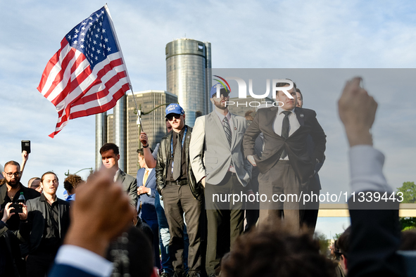 Members of America First, a far-right white Christian nationalist group, are holding a prayer while awaiting their leader Nick Fuentes to ar...