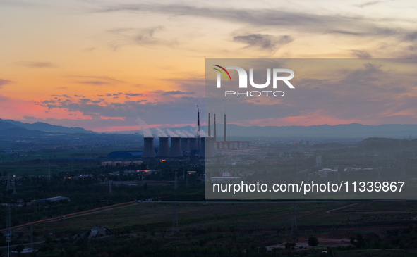 The Datang Electric Power Zhangjiakou Power Plant is being seen at sunset in Zhangjiakou, China, on June 17, 2024. 