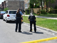 The crime scene unit is collecting evidence. Two people are being shot on W. Maple Street in Chicago, Illinois, United States, on June 17, 2...