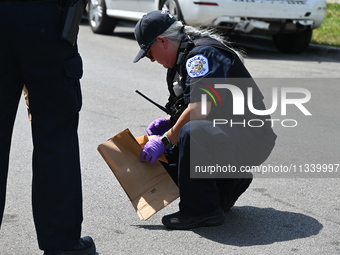 The crime scene unit is collecting evidence at the crime scene. Two people are being shot on W. Maple Street in Chicago, Illinois, United St...