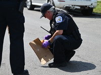 The crime scene unit is collecting evidence at the crime scene. Two people are being shot on W. Maple Street in Chicago, Illinois, United St...