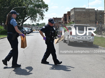 The crime scene is collecting evidence at the crime scene. Two people are being shot on W. Maple Street in Chicago, Illinois, United States,...