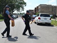 The crime scene is collecting evidence at the crime scene. Two people are being shot on W. Maple Street in Chicago, Illinois, United States,...