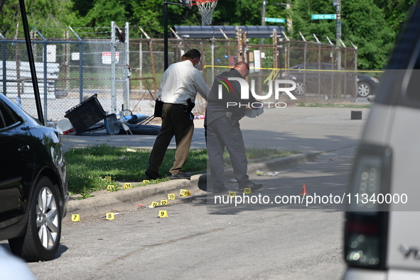 Several shell casings are being discovered on the scene. Two people are being shot on S. Burnside Avenue in Chicago, Illinois, United States...