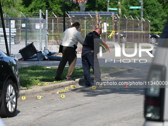 Several shell casings are being discovered on the scene. Two people are being shot on S. Burnside Avenue in Chicago, Illinois, United States...