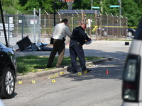 Several shell casings are being discovered on the scene. Two people are being shot on S. Burnside Avenue in Chicago, Illinois, United States...