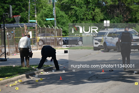 Several shell casings are being discovered on the scene. Two people are being shot on S. Burnside Avenue in Chicago, Illinois, United States...