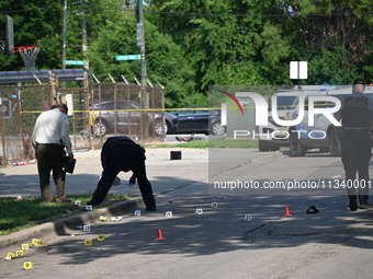 Several shell casings are being discovered on the scene. Two people are being shot on S. Burnside Avenue in Chicago, Illinois, United States...