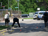 Several shell casings are being discovered on the scene. Two people are being shot on S. Burnside Avenue in Chicago, Illinois, United States...