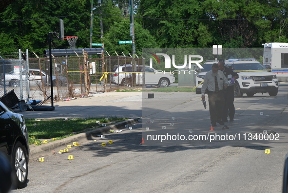 Several shell casings are being discovered on the scene. Two people are being shot on S. Burnside Avenue in Chicago, Illinois, United States...