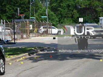 Several shell casings are being discovered on the scene. Two people are being shot on S. Burnside Avenue in Chicago, Illinois, United States...