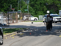 Several shell casings are being discovered on the scene. Two people are being shot on S. Burnside Avenue in Chicago, Illinois, United States...