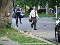 Several shell casings are being discovered on the scene. Two people are being shot on S. Burnside Avenue in Chicago, Illinois, United States...