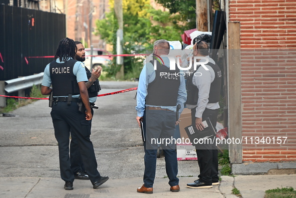 Chicago police officers are investigating in the alley where the shooting is occurring. One person is killed and one person is injured in a...