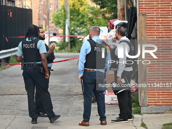 Chicago police officers are investigating in the alley where the shooting is occurring. One person is killed and one person is injured in a...