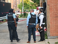 Chicago police officers are investigating in the alley where the shooting is occurring. One person is killed and one person is injured in a...