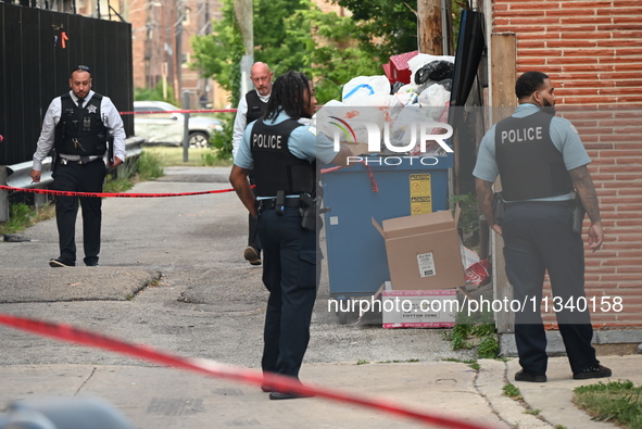 Chicago police officers are investigating in the alley where the shooting is occurring. One person is killed and one person is injured in a...