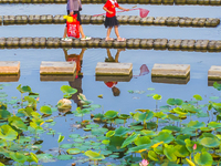 Citizens are bringing their children to play, fish, and catch lobsters at a wetland park in Suqian, Jiangsu province, China, on June 17, 202...