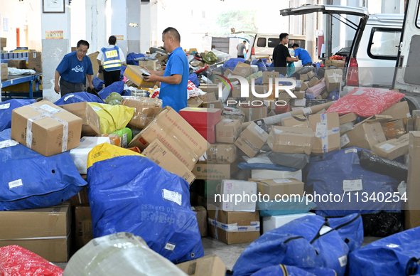 Workers are sorting parcels at an express logistics company in Taicang, China, on June 18, 2024. 